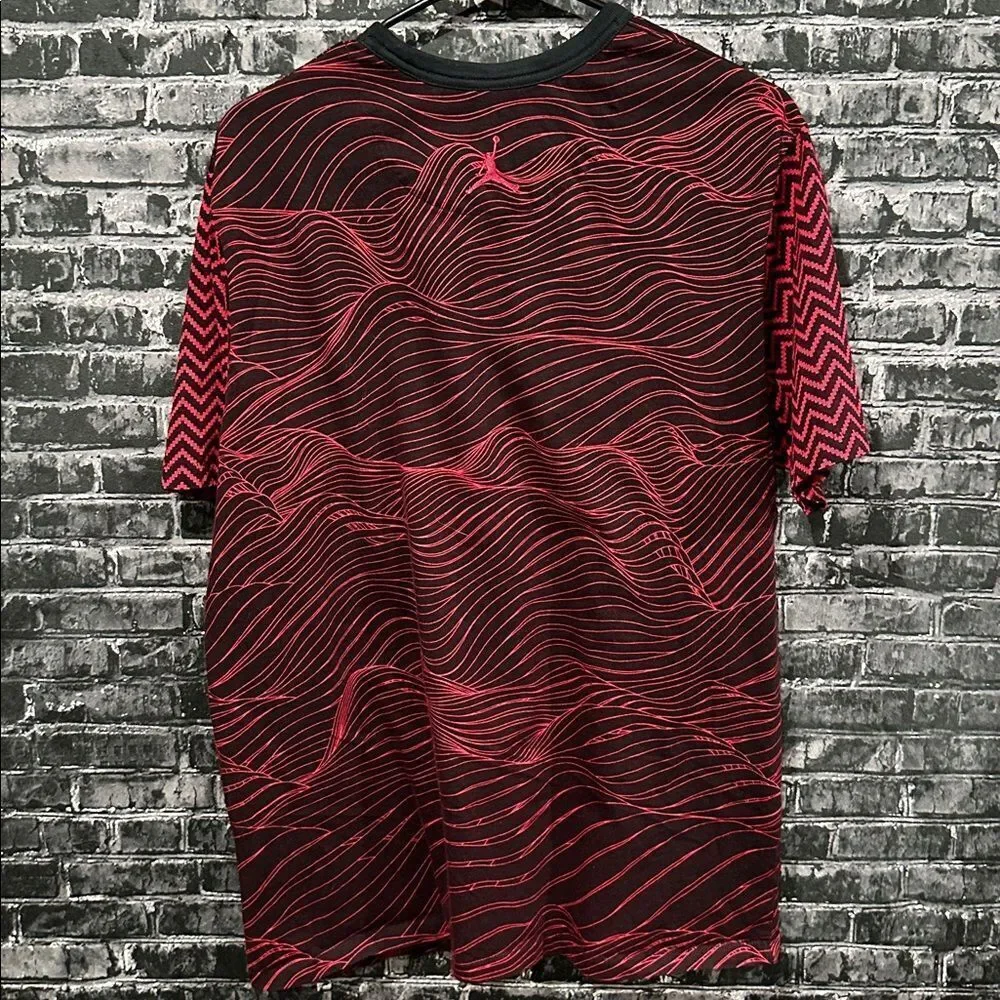 Jordan men's tee in red and black with a unique all-over pattern and a pocket.